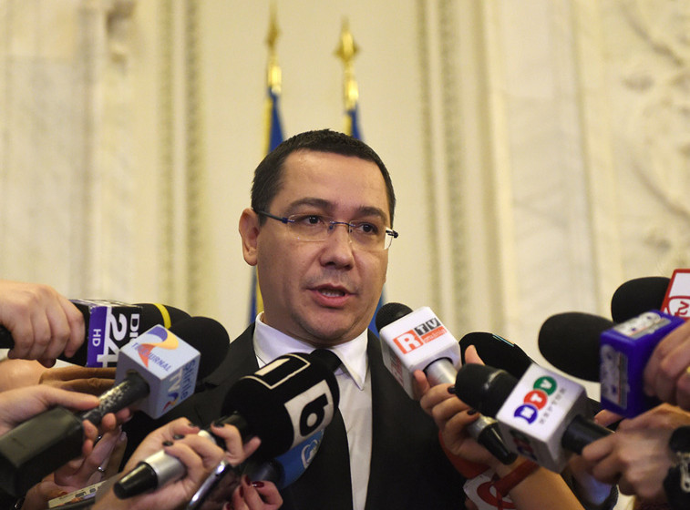 Romania's embattled Prime Minister Victor Ponta addresses journalists as he gets out from the governmental coalition meeting 