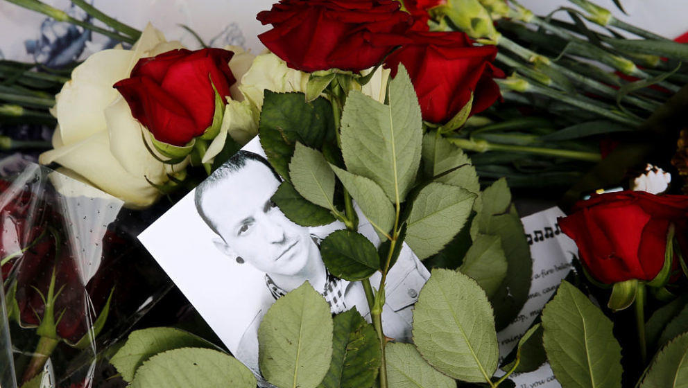 A picture taken on July 22, 2017 shows red roses and a picture of  Linkin Park frontman Chester Bennington laid in front of t