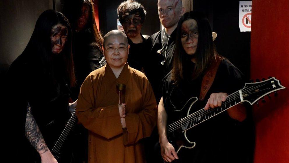 This picture taken on December 3, 2020 shows members of Taiwanese death metal band 'Dharma' posing for photographs during a r